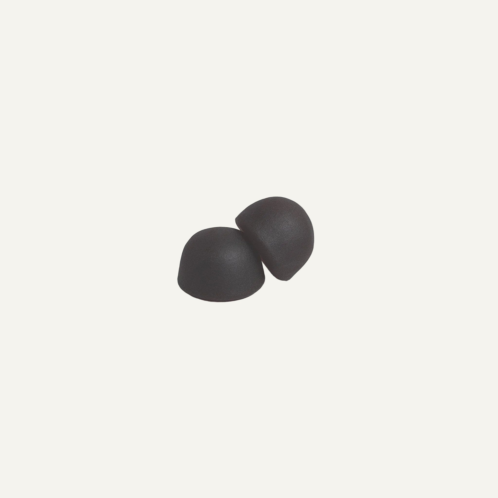 Two gray earbuds on a light gray background
